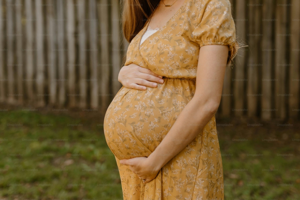 A pregnant woman holds her belly