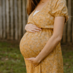 A pregnant woman holds her belly