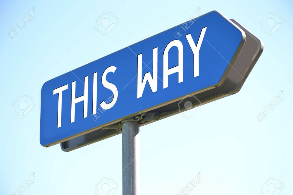 A sign pointing to the right that says "This Way"