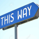 A sign pointing to the right that says "This Way"