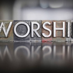 The word 'Worship' spelled out in wooden inkstamp blocks